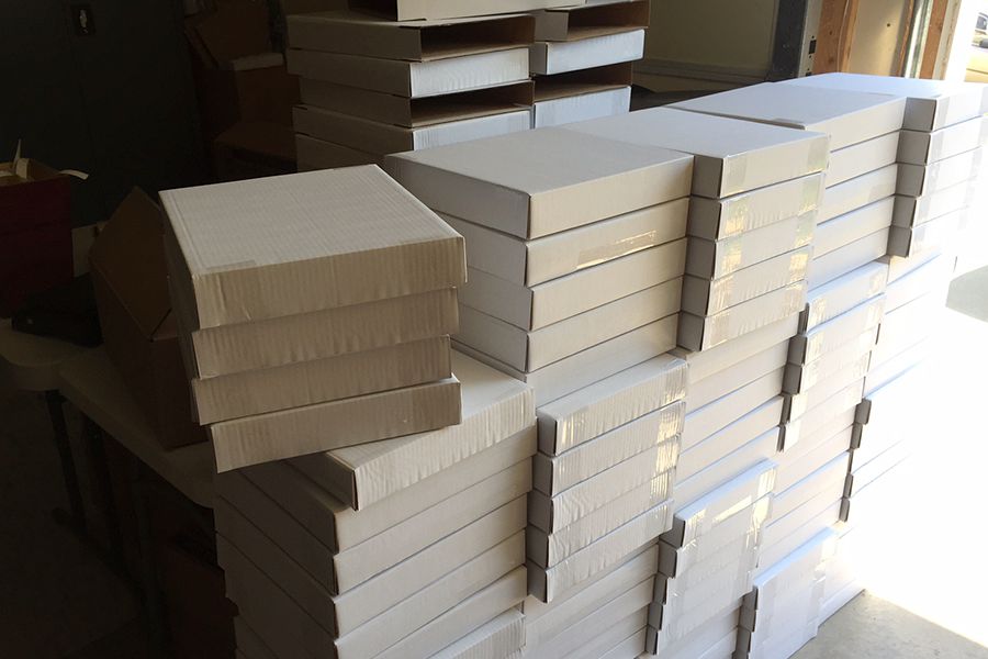 A stack of boxes ready to be filled. Boxes come from the vendor flat-packed, so assembling them is a set in the fulfillment process. We go through about 1000 boxes a month!