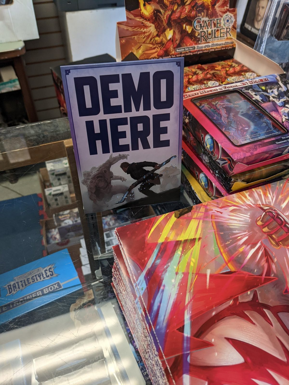 A photo of fantasy books with a Cypher Cypher System sign that says "Demo Here"